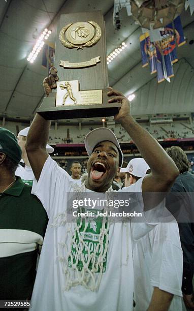 Mateen Cleaves of Michigan State celebrates with the National Championship trophy after defeating Florida 89-76 to win the final round of the NCAA...