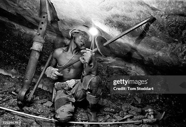 Miner excavating gold at the Kloof Gold Mine near Carltonville, South Africa. Miners work thousands of metres underground in extreme temperatures to...