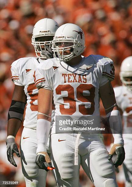 Defensive ends Brian Robison and Tim Crowder of the Texas Longhorns stand on the field during the Red River Shootout against the Oklahoma Sooners at...