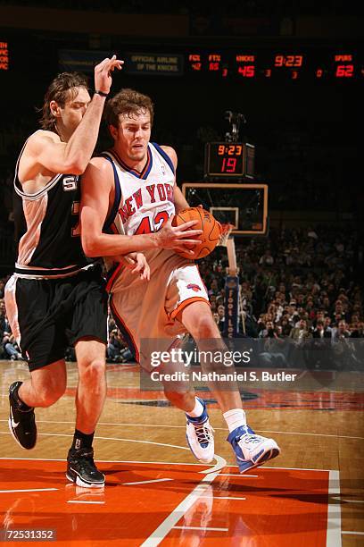 David Lee of the New York Knicks drives to the basket against Fabricio Oberto of the San Antonio Spurs during a game at the Madison Square Garden on...