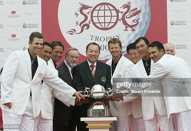 The team of International players celebrate their victory with Sir Terry Matthews OBE, Chairman of The Celtic Manor Resort and Doctor David Chu,...