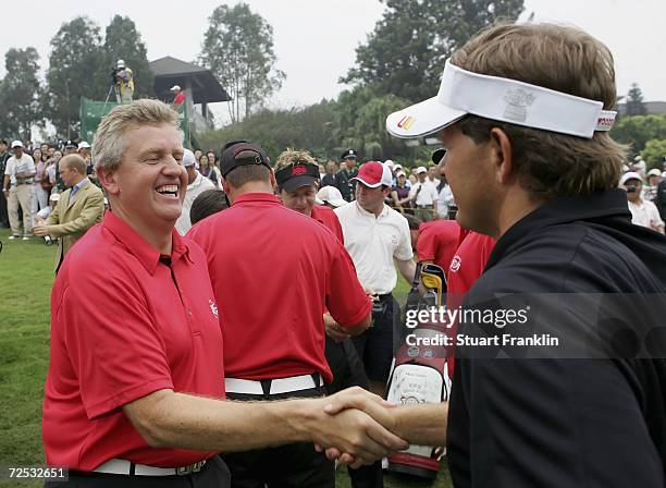 Colin Montgomerie, Captain of The team of Ryder Cup Nations team congratulates Retief Goosen, Captain of The International team on his teams victory...