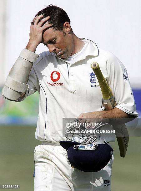 England cricketer Marcus Trescothick walks back to the pavillion after he was dismissed by Pakistani bowler Shabbir Ahmed during the third day of the...