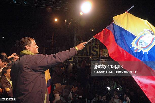 Presidential candidate Rafael Correa, of the Country Alliance party, waves an Ecuadorean flag during the final rally of his campaign on October 12th...