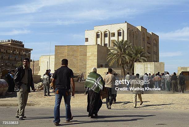 Iraqis gather in front of an Iraqi Higher Education building where some 100 government employees and visitors were kidnapped on November 14, 2006 in...