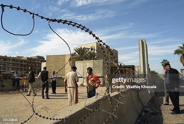 Iraqis gather in front of an Iraqi Higher Education building where some 100 government employees and visitors were kidnapped on November 14, 2006 in...