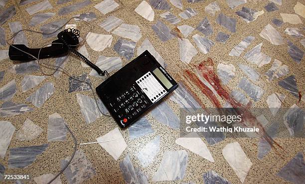 Telephone set is seen near smeared blood at an Iraqi Higher Education building where some 100 government employees and visitors were kidnapped on...
