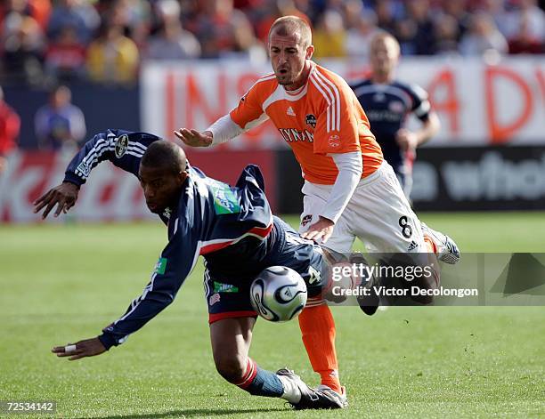 Paul Dalglish of the Houston Dynamo bowls over Avery John of the New England Revolution during the 2006 MLS Cup at Pizza Hut Park on November 12,...