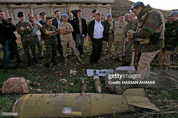 Belgian Defense Minister Andre Flahaut listens to explanation of a Belgian officer on how to demine unexploded ordinance inside his base in the...
