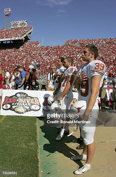 Punt kickers Ryan Bailey and Greg Johnson of the Texas Longhorns stand at attention during the national anthem before the Red River Shootout against...