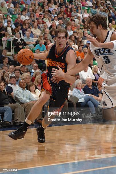 Troy Murphy of the Golden State Warriorsdrives to the basket against Mehmet Okur of the Utah Jazz during the game on November 4, 2006 at the Delta...