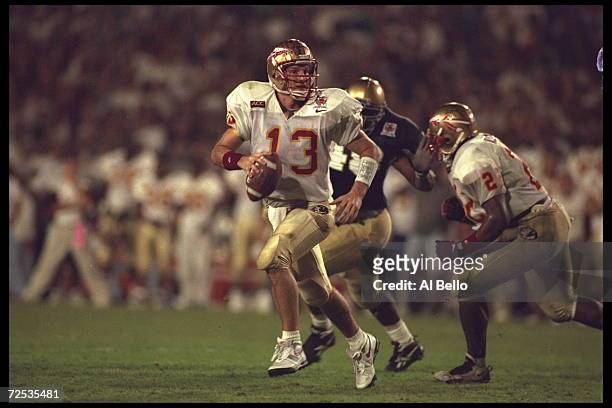Quarterback Danny Kanell of the Florida State Seminoles is chased out of the pocket by a Notre Dame Fighting Irish defender during the Orange Bowl in...