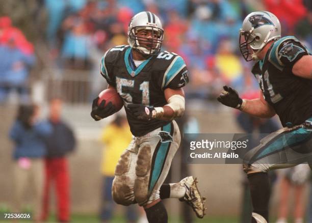 Linebacker Sam Mills of the Carolina Panthers carries the football after a turn over during the Panthers 24-0 win over the Tampa Bay Buccaneers at...
