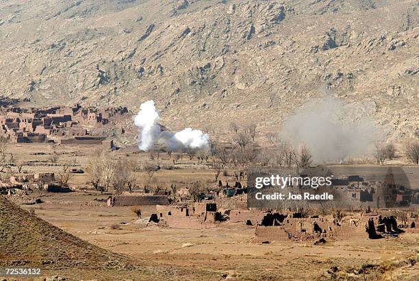 Smoke billows from rockets fired from Marine Cobra helicopters March 10, 2002 in the villages of Sherkhankheyl, Marzak and Bobelkiel, Afghanistan....