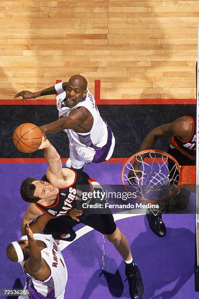 Center Chris Dudley of the Portland Trail Blazers shoots the ball as forward Keon Clark of the Toronto Raptors attempts to block during the NBA game...