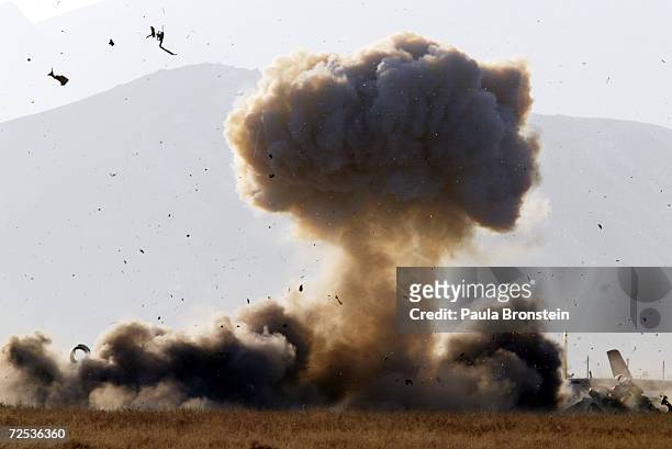 An SU-21 Russian Fitter aircraft is blown up with explosives by the British Royal Air Force Bomb disposal squadron February 11, 2002 at Kabul...