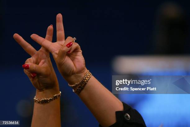 Woman makes a W sign with her hands on night three of the Republican National Convention September 1, 2004 at Madison Square Garden in New York City.