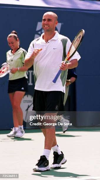 Tennis star Andre Agassi plays a match August 26, 2000 at the Arthur Ashe Kids'' Day Family and Music Festival at the USTA National Tennis Center in...