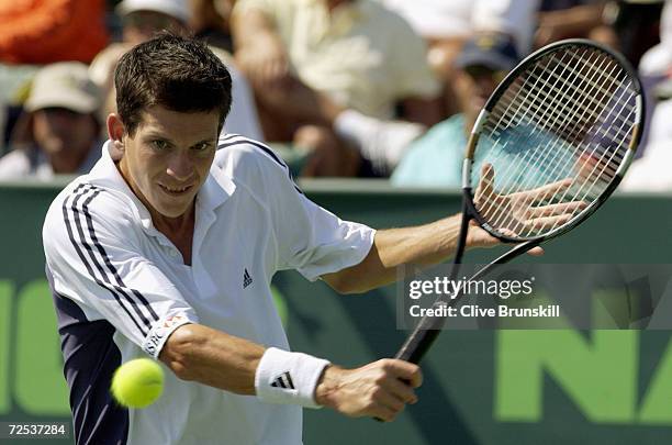 Tim Henman of Great Britain returns a shot to Lars Burgsmuller of Germany during the Nasdaq-100 Open at The Tennis Center at Crandon Park in Miami,...