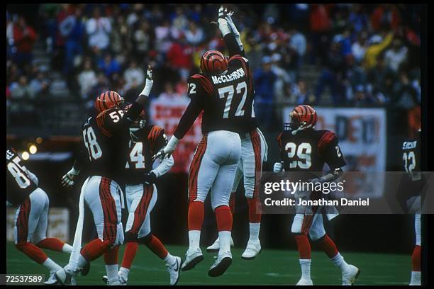 The Cincinnati Bengals celebrate during a game against the Houston Oilers at Riverfront Stadium in Cincinnati, Ohio. The Bengals won the game, 44-21....