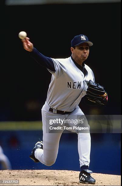 Pitcher Ramiro Mendoza of the New York Yankees throw the ball during the game against the Detroit Tigers at the Tiger Stadium in Detroit, Michigan....