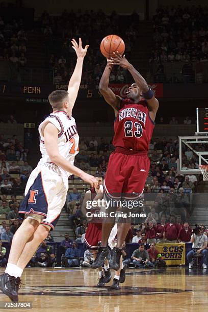 Michael Jordan of the Pennsylvania Quakers shoots over Illinois Fighting Illini''s Sean Harrington during their first-round NCAA East Regional game...