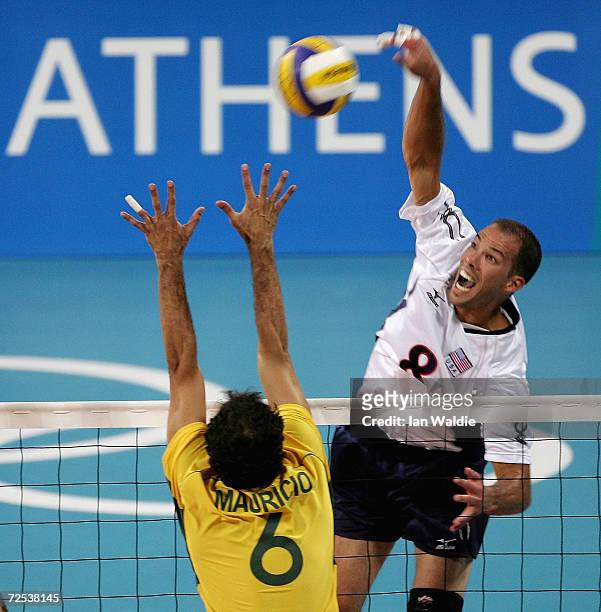William Priddy of the USA spikes the ball past Mauricio Lima of Brazil in the men's indoor Volleyball preliminary match on August 23, 2004 during the...