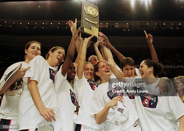 Connecticut holds the National Championship trophy after they beat Tennessee 71-52 during the NCAA Women''s Final Four at the First Union Center in...