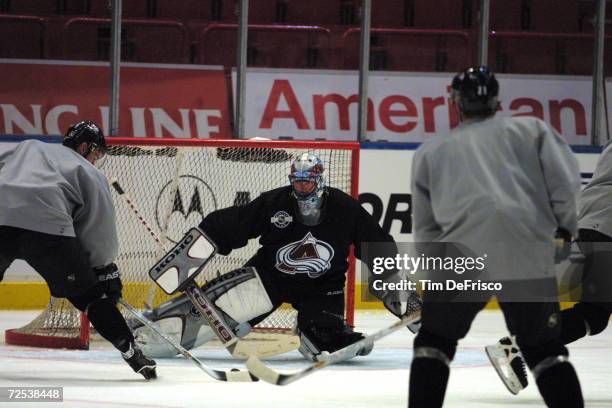 Right wing Chris Drury, left, gets ready to take a shot on Avalanche goaltender Patrick Roy of the Colorado Avalanche during a training camp session...