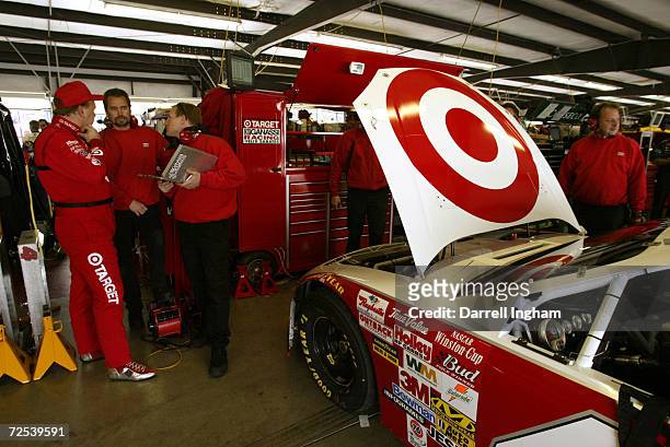 Jimmy Spencer driver of the Target Ganassi Racing Dodge Intrepid R/T with members of his engineering crew during the NASCAR Winston Cup Subway 400 at...