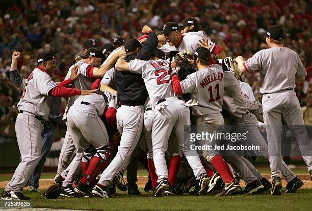 The Boston Red Sox celebrate on the field after defeating the St. Louis Cardinals 3-0 in game four of the World Series on October 27, 2004 at Busch...