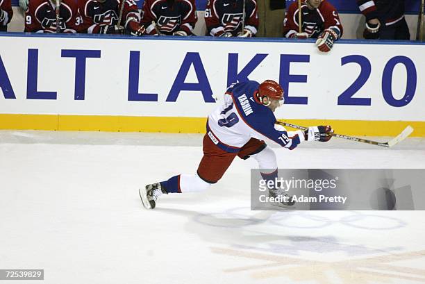 Alexei Yashin of Russia shoots the puck deep into the USA zone during men's semifinals at the Salt Lake City Winter Olympic Games at the E Center in...