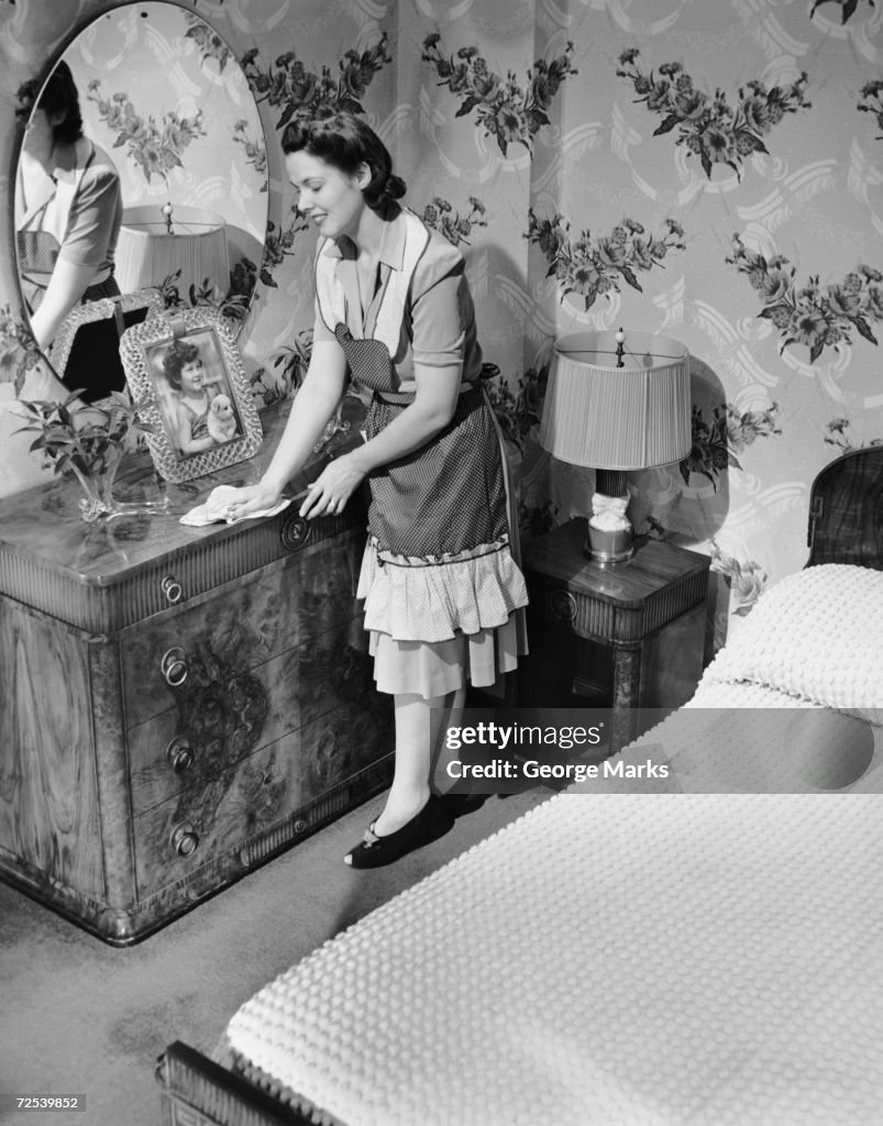 Woman house cleaning in bedroom. News Photo - Getty Images