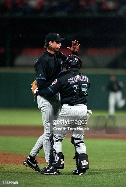 Pitcher Randy Johnson of the Arizona Diamondbacks is being hugged by Catcher Kelly Stinnett during a game against the San Francisco Giants at 3Com...
