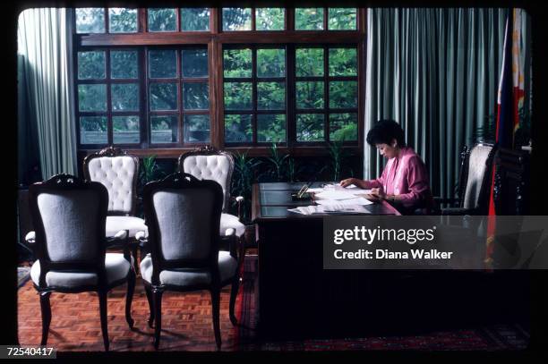 Corazon Aquino sits at her desk December 4, 1986 in Manila, Philippines. Widow of assassinated Filipino senator Benigno Aquino, Corazon Aquino became...