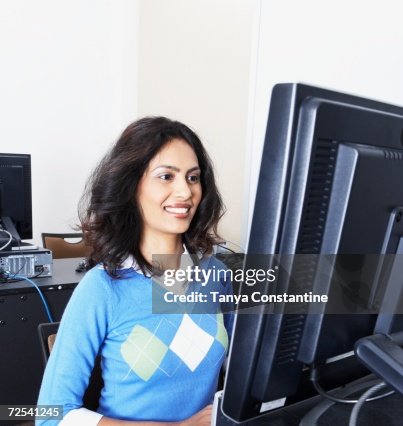 Indian Woman Using Computer And Smiling High-Res Stock Photo - Getty Images