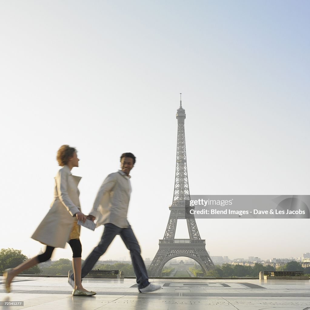 Couple walking with Eiffel Tower in background