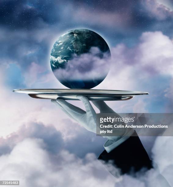 butler's hand holding planet earth on silver platter - butler stock illustrations