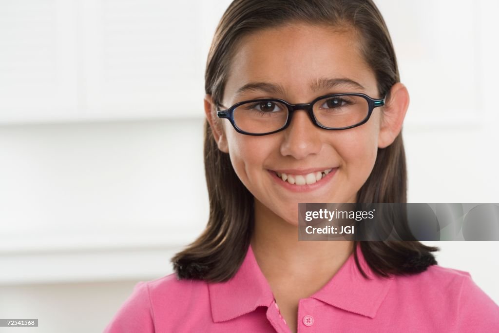 Hispanic girl wearing eyeglasses and smiling