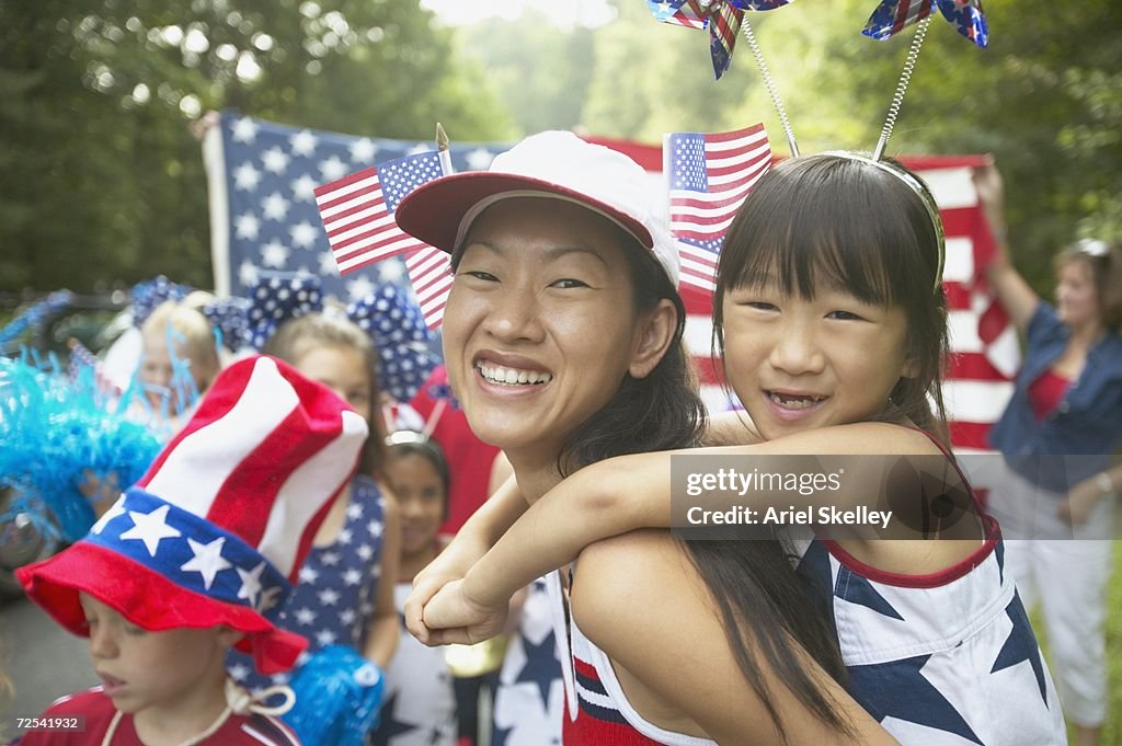 Asian mother and daughter in Fourth of July parade