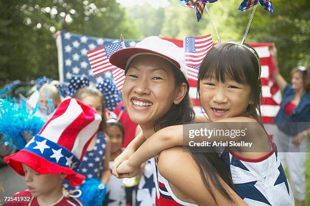 asian mother and daughter in fourth of july parade - america parade imagens e fotografias de stock