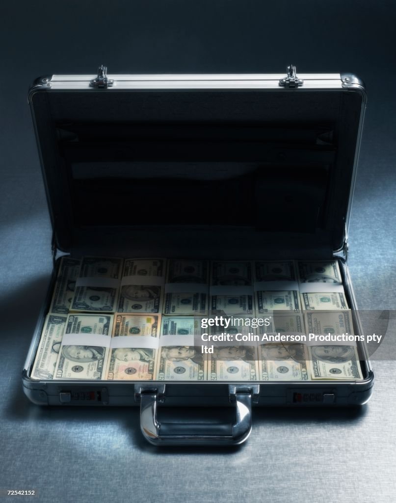 Briefcase filled with stacks of US Dollars