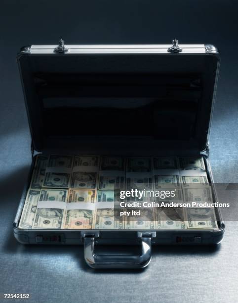 briefcase filled with stacks of us dollars - corruption stock pictures, royalty-free photos & images