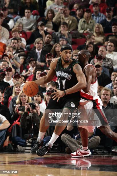 Eddie Griffin of the Minnesota Timberwolves moves around Travis Outlaw of the Portland Trail Blazers during the game at Rose Garden on November 4,...