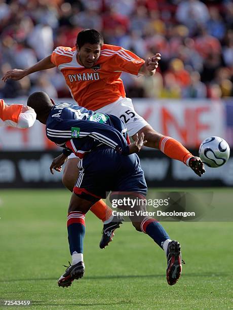 Brian Ching of the Houston Dynamo clashes with Avery John of the New England Revolution as they vie for the ball during the 2006 MLS Cup at Pizza Hut...