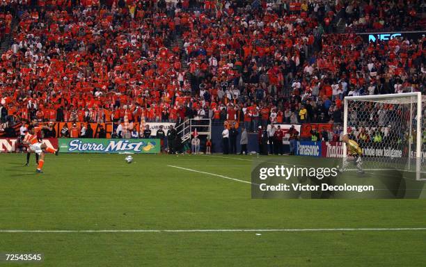 Goaltender Matt Reis of the New England Revolution faces a shot by Brian Ching of the Houston Dynamo during penalty kicks at Pizza Hut Park on...