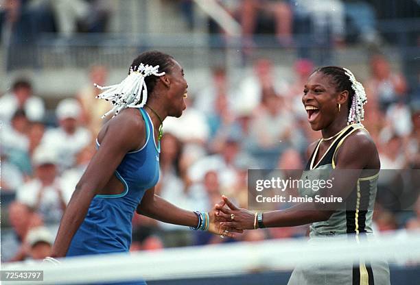 Venus Williams and Serena Williams of the USA celebrate after the doubles match against Mary Joe Fernandez and Monica Seles of the USA in the US Open...