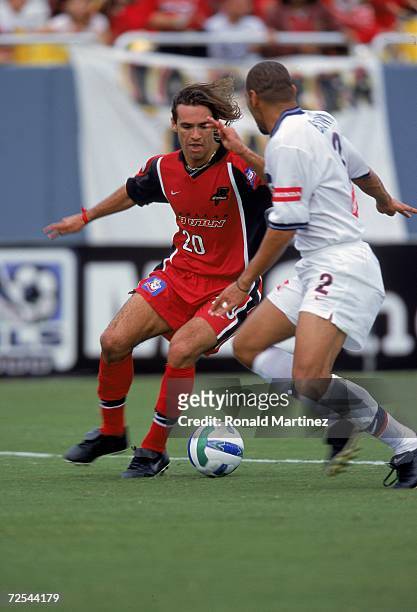 Ariel Grazini of the Dallas Burn fights for the ball with C.J. Brown of the Chicago Fire at the Cotton Bowl in Dallas, Texas. The Burn defeated the...