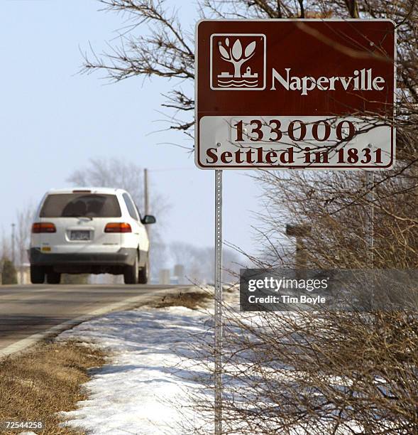 Motor vehicle passes a sign February 8, 2002 as it enters Naperville, IL. Naperville, a community of 133,000 west of Chicago, has voted to require...