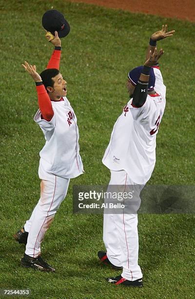 Orlando Cabrera and David Ortiz of the Boston Red Sox celebrate after defeating the St. Louis Cardinals 6-2 in game two of the World Series on...
